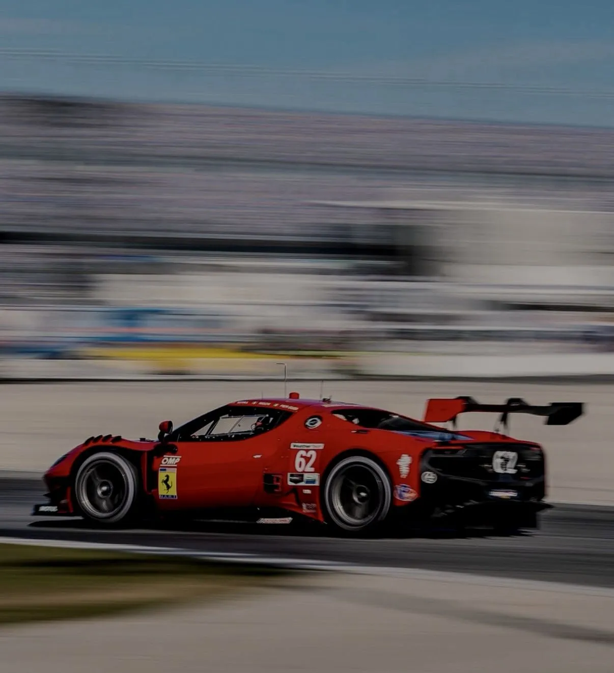 Ferrari race car on track representing elite experiences and access