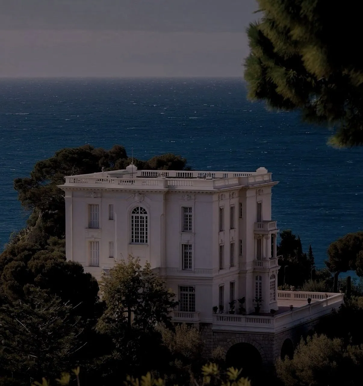 Coastal villa residence overlooking open water with private grounds